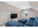 Finished bonus room with plush seating, large television, and bright window creating a relaxing entertainment space at 955 Lynch Rd, Selma, NC 27576