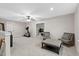 Spacious bonus room with neutral decor, exercise equipment, and sitting area provides a versatile living space at 955 Lynch Rd, Selma, NC 27576