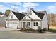 Beautifully designed home featuring a large garage, manicured lawn, and inviting front porch at 955 Lynch Rd, Selma, NC 27576
