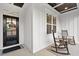 Charming front porch with rocking chairs and a decorative wreath on the front door at 955 Lynch Rd, Selma, NC 27576