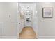 Bright hallway with wood floors, white trim, and stylish decor, leading to the front door at 955 Lynch Rd, Selma, NC 27576