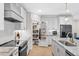 Bright kitchen features white cabinets, stainless steel appliances, and a walk-in pantry at 955 Lynch Rd, Selma, NC 27576