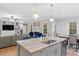 Open-concept kitchen with island, granite countertops, and views of the living room at 955 Lynch Rd, Selma, NC 27576