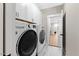 Well-equipped laundry room with modern washer and dryer, ample cabinet space, and sleek design for convenience at 955 Lynch Rd, Selma, NC 27576