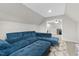 Comfortable living area showcases a plush blue sofa, soft carpeting, and a cozy space for relaxation and entertainment at 955 Lynch Rd, Selma, NC 27576