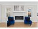 Cozy living room featuring a modern fireplace, herringbone tile, and large windows for ample natural light at 955 Lynch Rd, Selma, NC 27576