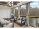 Cozy screened-in porch with comfortable seating, stylish decor, and a view of the backyard at 955 Lynch Rd, Selma, NC 27576