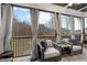 Relaxing screened-in porch with comfortable seating, curtains, and a view of the backyard at 955 Lynch Rd, Selma, NC 27576