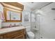 Bathroom featuring a glass enclosed shower, wood cabinets, and great lighting at 1 Nicklaus Way, Clayton, NC 27520