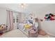 Bright bedroom with a cute bed, lovely decor, and plush carpet at 1 Nicklaus Way, Clayton, NC 27520
