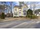 Charming two-story yellow home with well-manicured landscaping at 1 Nicklaus Way, Clayton, NC 27520