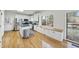 Well-lit kitchen with stainless steel appliances, white cabinetry, and a view to the backyard at 1 Nicklaus Way, Clayton, NC 27520