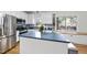Bright kitchen with an island, stainless steel appliances, and classic backsplash tiles at 1 Nicklaus Way, Clayton, NC 27520