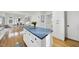 Open-concept kitchen island flowing into the dining room, offering ample storage and style at 1 Nicklaus Way, Clayton, NC 27520