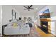 Bright living room with a fireplace, hardwood floors, and a comfortable gray sectional sofa at 1 Nicklaus Way, Clayton, NC 27520