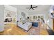 Open-concept living room with hardwood floors, fireplace, and view of the dining area and staircase at 1 Nicklaus Way, Clayton, NC 27520