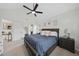 Spacious primary bedroom featuring a ceiling fan, windows, and a comfortable king-sized bed at 1 Nicklaus Way, Clayton, NC 27520