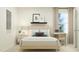 Cozy bedroom features a wooden bed frame, a small desk area, and neutral decor for a comfortable living space at 10068 Regal Dr, Angier, NC 27501