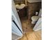 Cozy half bathroom with ceramic tile flooring, a sink, and a toilet tucked under the stairs at 1025 Shellrock Dr Dr, Wake Forest, NC 27587