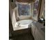 Bright bathroom featuring a soaking tub by a large window at 1025 Shellrock Dr Dr, Wake Forest, NC 27587
