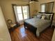 Cozy bedroom features hardwood floors, a ceiling fan, and a large window with backyard views at 1025 Shellrock Dr Dr, Wake Forest, NC 27587