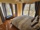 Bedroom boasts hardwood floors, bright windows, and a queen bed with patterned bedding at 1025 Shellrock Dr Dr, Wake Forest, NC 27587