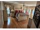 Spacious bedroom with hardwood floors, a ceiling fan, and large windows with custom curtains at 1025 Shellrock Dr Dr, Wake Forest, NC 27587