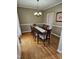 Elegant dining room with wood floors, wainscoting, and a modern chandelier at 1025 Shellrock Dr Dr, Wake Forest, NC 27587