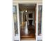 Inviting foyer with decorative wood floors and glass sidelights flanking the entryway door at 1025 Shellrock Dr Dr, Wake Forest, NC 27587