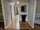 Hallway view featuring hardwood floors, neutral walls, and elegant decor at 1025 Shellrock Dr Dr, Wake Forest, NC 27587