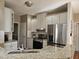 Bright kitchen features granite countertops, stainless steel appliances, and white cabinetry at 1025 Shellrock Dr Dr, Wake Forest, NC 27587