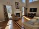 Light-filled living room with a fireplace, hardwood floors, and a comfortable seating area at 1025 Shellrock Dr Dr, Wake Forest, NC 27587