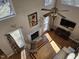 Elevated view of a sunlit living room with hardwood floors, fireplace, and large windows at 1025 Shellrock Dr Dr, Wake Forest, NC 27587