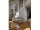 Bright living room features hardwood floors, staircase, and a comfortable cream-colored sofa at 1025 Shellrock Dr Dr, Wake Forest, NC 27587