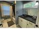 Bathroom with a window next to the shower with updated vanity and dark brown sink at 105 Johnson St, Chapel Hill, NC 27516