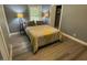 Bedroom with hardwood floors, a window and two lamps on either side of the bed at 105 Johnson St, Chapel Hill, NC 27516
