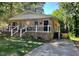 Charming brick home featuring a cozy front porch and well-manicured lawn at 105 Johnson St, Chapel Hill, NC 27516
