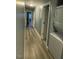 Hallway with hardwood floors, modern lighting, and a washer and dryer at 105 Johnson St, Chapel Hill, NC 27516