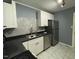 Modern kitchen with white cabinets, dark countertops and stainless steel appliances at 105 Johnson St, Chapel Hill, NC 27516