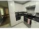 Modern kitchen with white cabinets, dark countertops and stainless steel appliances at 105 Johnson St, Chapel Hill, NC 27516