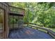 Expansive wooden deck features a screened-in porch, built-in bench, and lush, wooded surroundings for outdoor living at 110 Ironwood Pl, Chapel Hill, NC 27514