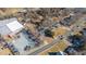 An aerial view reveals charming homes along a road with businesses nearby, all under a bright sky at 1127 W Webb Ave, Burlington, NC 27217