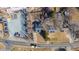An aerial shot displays a home with a dark roof amidst a mix of buildings, with parking areas adjacent at 1127 W Webb Ave, Burlington, NC 27217