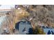 Aerial shot of a house with a dark roof next to a fenced lot in a neighborhood with bare trees at 1127 W Webb Ave, Burlington, NC 27217