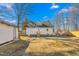 Backyard with wooden fence, storage shed, and detached garage at 1127 W Webb Ave, Burlington, NC 27217