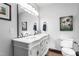 A bright bathroom featuring a double sink vanity and decorative wall art at 1127 W Webb Ave, Burlington, NC 27217