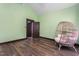 Bedroom with an eclectic chair, modern floors and green walls at 1127 W Webb Ave, Burlington, NC 27217