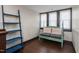 Sunlit bedroom featuring stylish seating, wood floors and large windows at 1127 W Webb Ave, Burlington, NC 27217