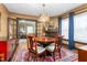 Elegant dining room with hardwood floors, fireplace, modern chandelier, and round wooden table at 1127 W Webb Ave, Burlington, NC 27217