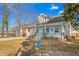 Beautiful home with a welcoming front porch, decorative accents, and landscaped yard at 1127 W Webb Ave, Burlington, NC 27217